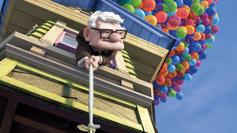 An old man holds a rope leaning out of the window of his house to thank for the multi-colored balloons.