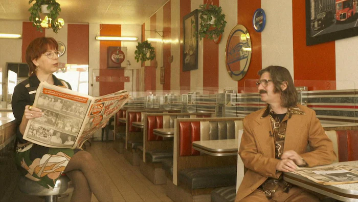 Chantal Lamarre and Jean-René Dufort chat in an old restaurant. 