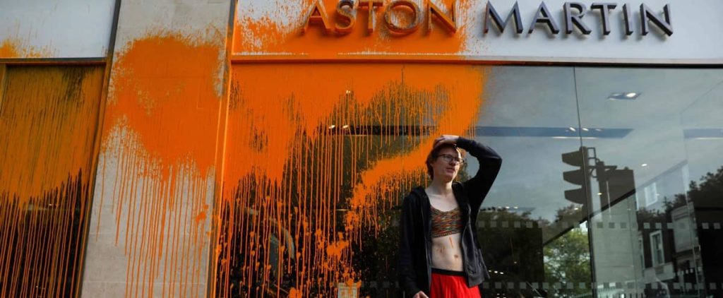 Environmental activists attack an Aston Martin car dealership in London